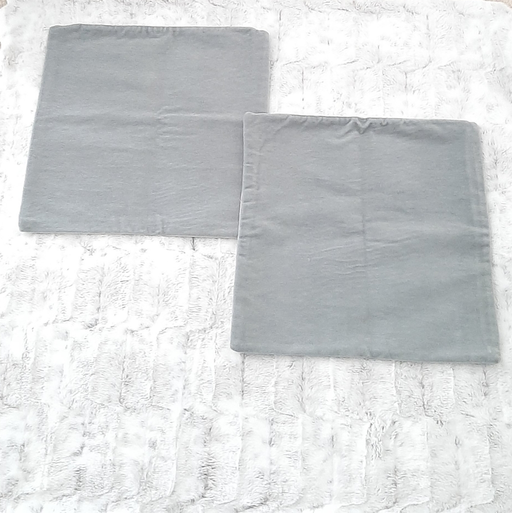 Blue gray zippered pillow covers.